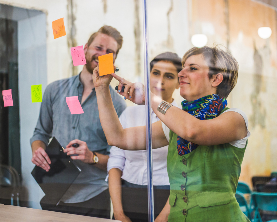 woman putting sticky notes on window