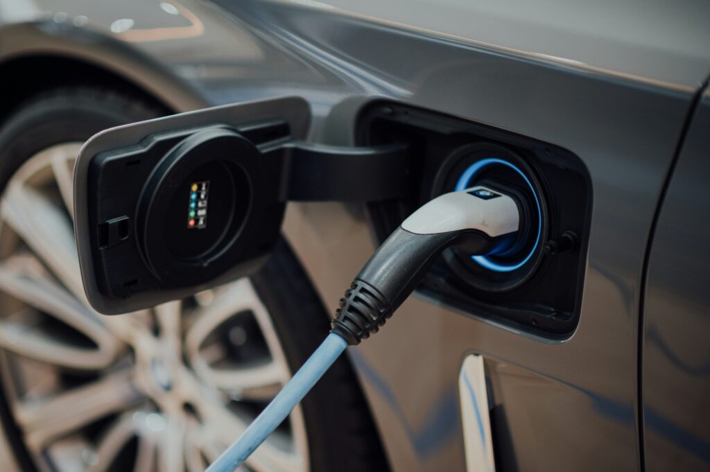 EV charging with cable connected to a parked electric car.