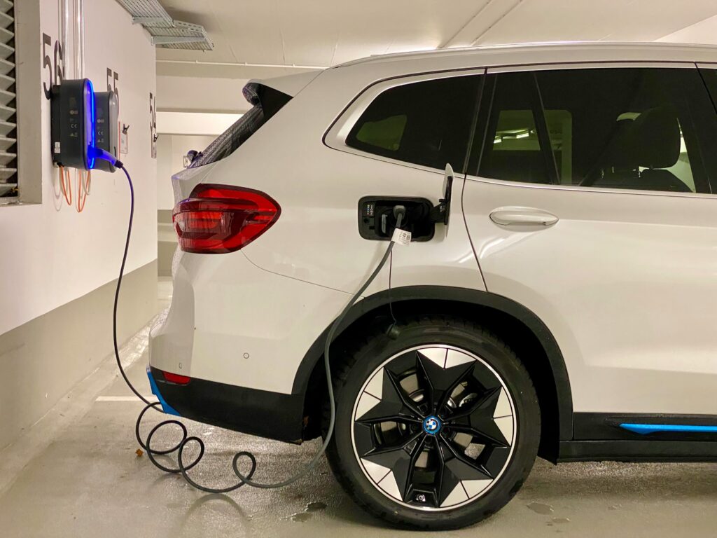 EV charging with cable connected to a parked electric car.